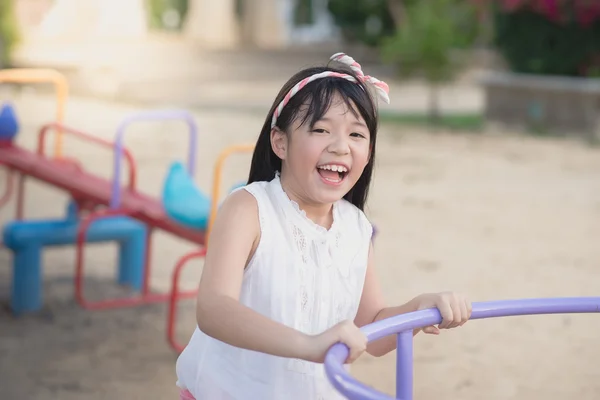Little asian child having fun on carousel — Stock Photo, Image
