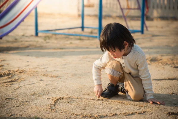 Criança brincando com areia — Fotografia de Stock