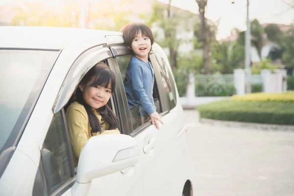 Heureux asiatique les enfants assis dans l 'voiture — Photo