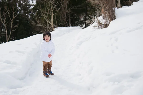 Portrait of asian boy in winter clothes with snow — Stock Photo, Image