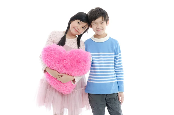 Asian boy and girl with heart pillow — Stock Photo, Image