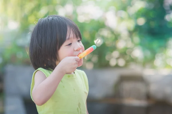 Asian child eating an ice cream outdoors — Stock Photo, Image