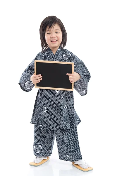 Cute asian boy holding black board on white background — Stock Photo, Image