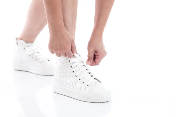Asian woman tying laces in her white sneakers — Stock Photo, Image