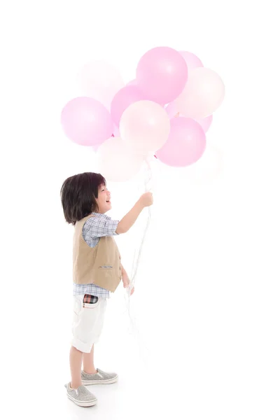 Niño asiático sosteniendo globos rosados y blancos —  Fotos de Stock