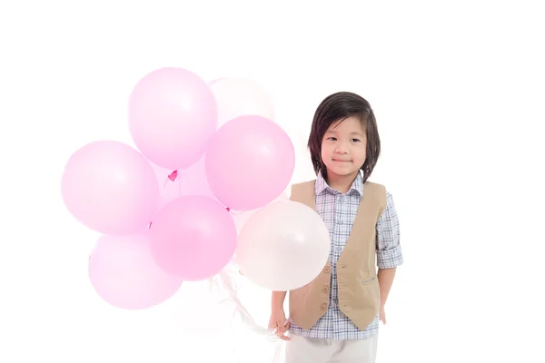 Niño asiático sosteniendo globos rosados y blancos —  Fotos de Stock