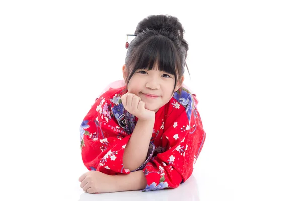 Beautiful Asian girl  in red kimono lying on white background isolated — Stock Photo, Image