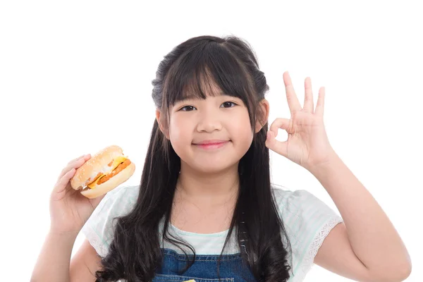 Beautiful asian girl eating hamburger — Stock Photo, Image