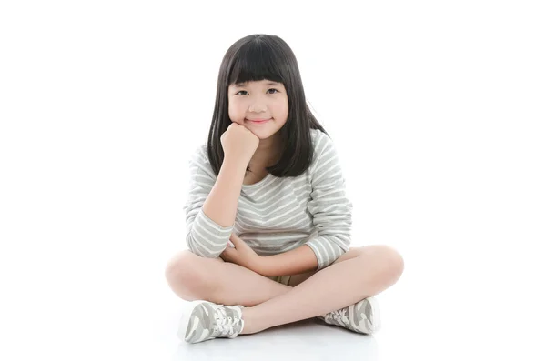 Beautiful asian girl sitting on white background — Stock Photo, Image