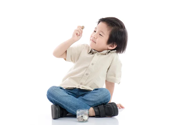 Leuke Aziatische kind geld besparen in glazen fles — Stockfoto