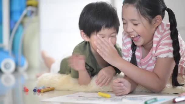 Cute Asian children drawing with crayon — Stock Video