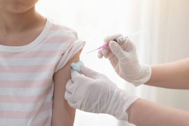 Asian child receiving injection or vaccine.Concept fight against virus covid-19 corona virus