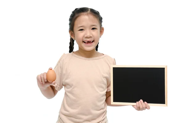 Asian girl holding egg and black board — Stock Photo, Image