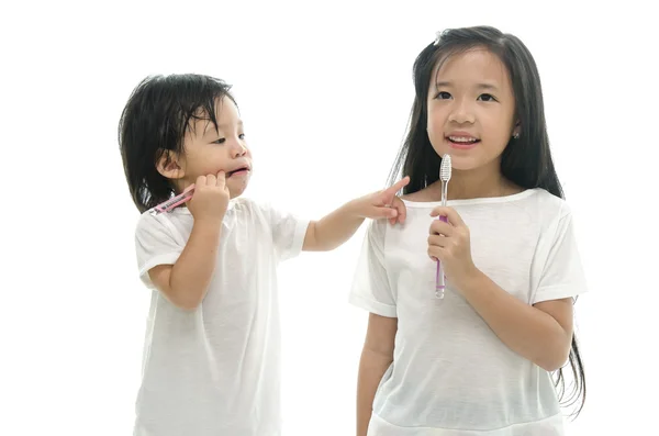 Kleine asiatische Mädchen und Jungen Zähne putzen — Stockfoto