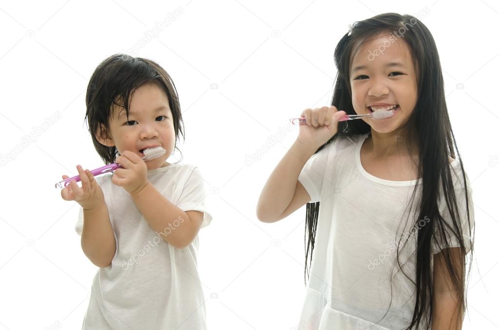 Little  asian girl and boy brushing teeth