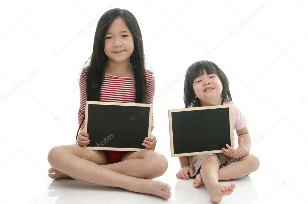 Little asian boy and girl sitting and holding  chalkboard