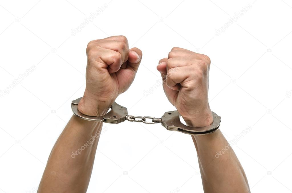 Man hands with handcuffs showing victory sign 