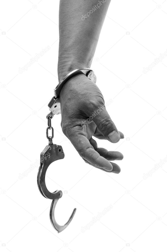 Man hands with handcuffs showing victory sign 
