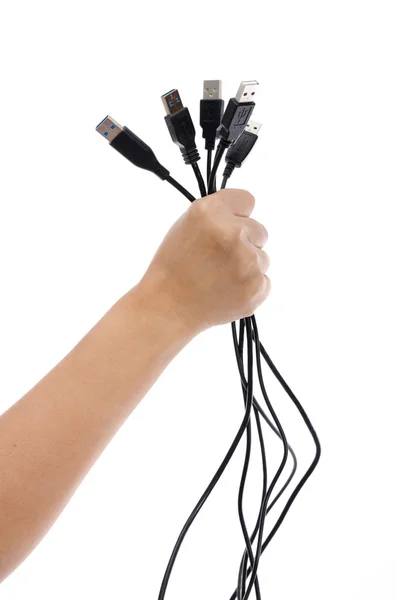 Mão segurando muitos cabo USB — Fotografia de Stock