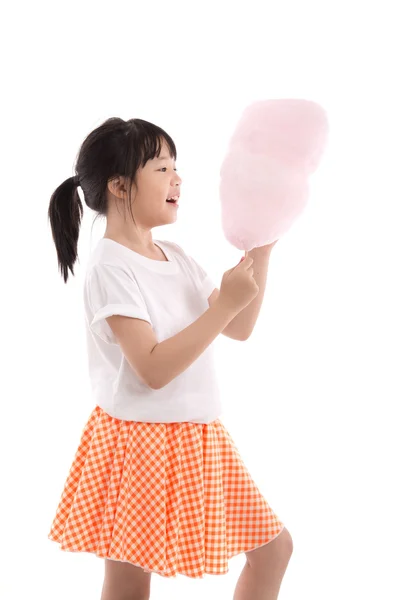 Cute asian girl holding pink cotton candy — Stock Photo, Image