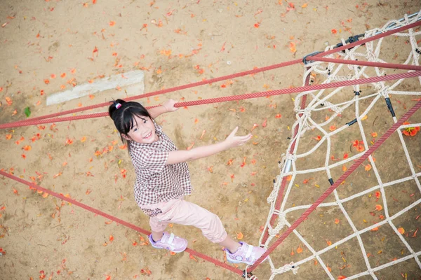 Asian girl is having fun in adventure park — Stock Photo, Image