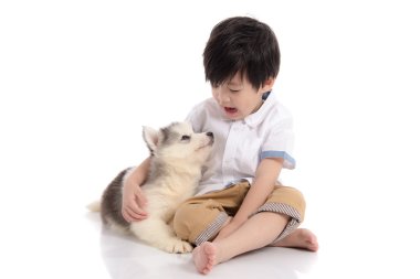 Sibirya husky yavrusu ile oturma sevimli Asya çocuk