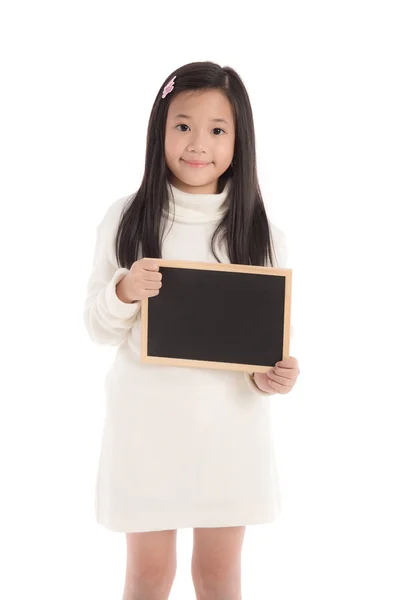 Cute asian girl in white turtleneck dress holding blackboard — Stock Photo, Image