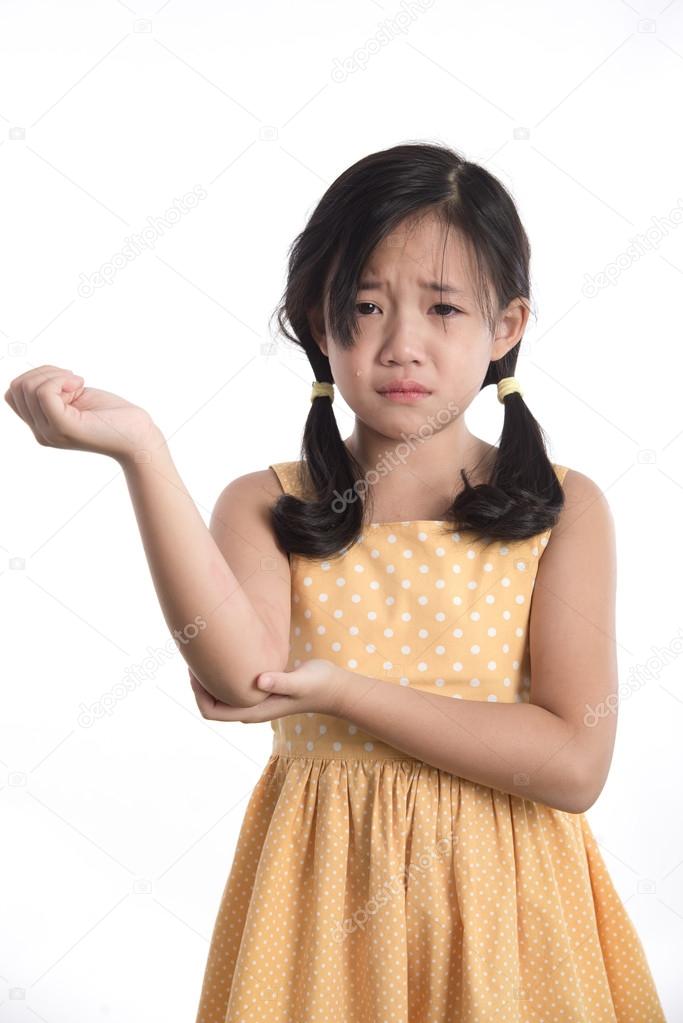 Beautiful asian girl crying on white background