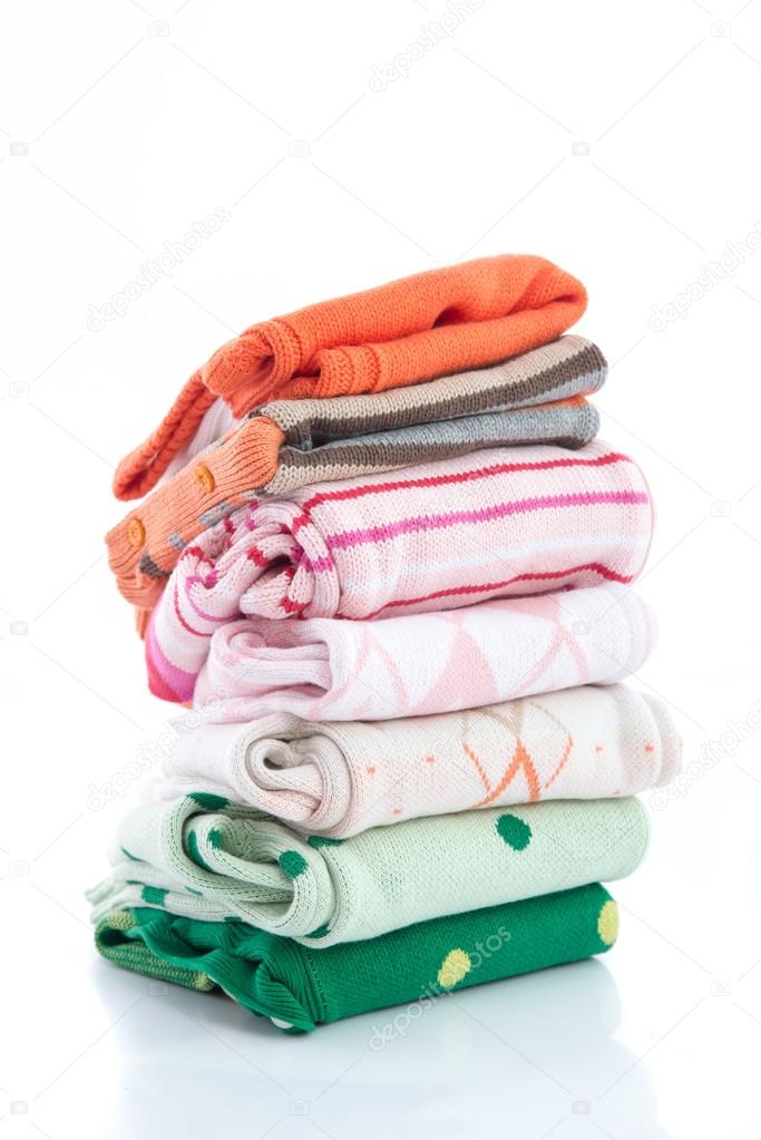 Stack of colorful cozy knitted sweaters