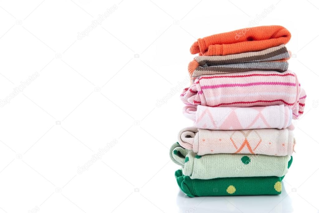 Stack of colorful cozy knitted sweaters