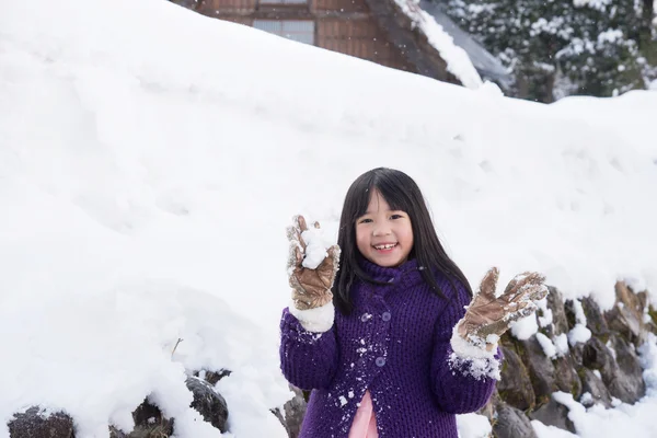 Cute asian girl smiling outdoors in snow — Stock Photo, Image