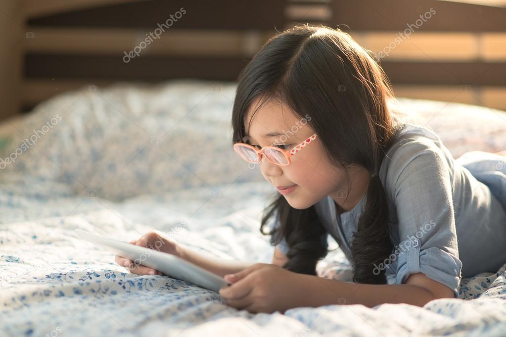 Beautiful asian girl using tablet