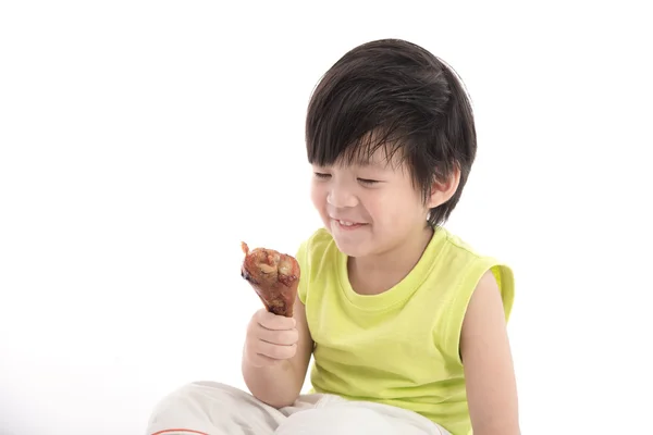 Cute asian boyeating roasted chicken — Stock Photo, Image