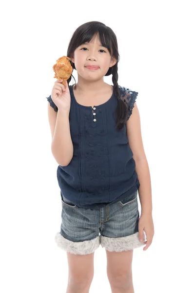 Cute asian girl eating fried chicken — Stock Photo, Image
