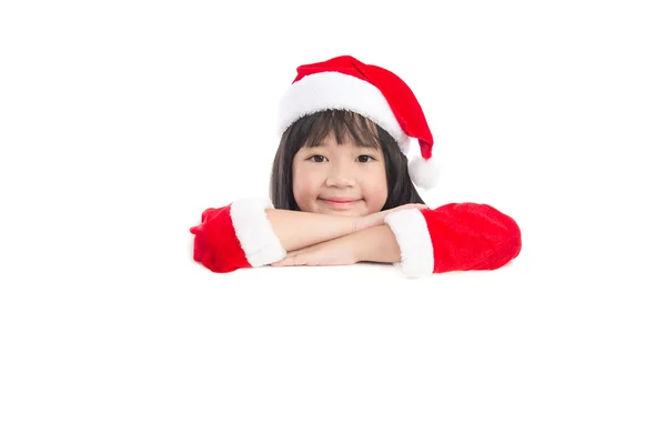 Little asian girl in  in Santa Claus  uniform with an empty bann Stock Picture