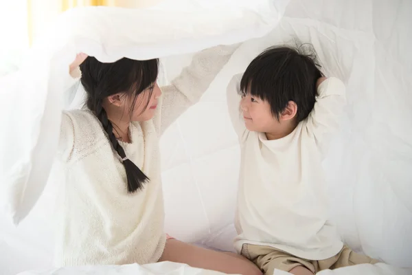 Cute asian children playing on bed — Stock Photo, Image