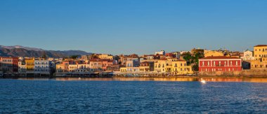 Beautiful view of Old Venetian port of Chania, Crete, Greece, shop, hotels, cafes and restaurants on quay.Maritime museum of Crete. Cretan mountains