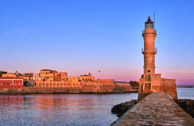 Egyptian or Venetian Lighthouse of Old Venetian harbour of Chania, Crete, Greece at sunrise. Soft sky colors from blue to pink, Firka castle walls.