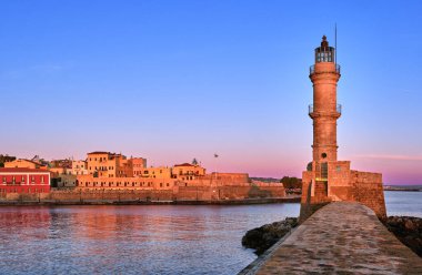 Egyptian or Venetian Lighthouse of Old Venetian harbour of Chania, Crete, Greece at sunrise. Soft sky colors from blue to pink, Firka castle walls. clipart
