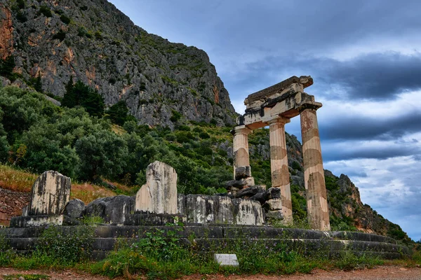 Ruiny Tholos starożytnej greckiej bogini Ateny Pronai w Delphi, Grecja. Odrestaurowałem trzy kolumny Dorica. Lista światowego dziedzictwa UNESCO. Widok z tyłu — Zdjęcie stockowe