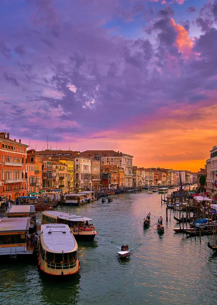 Sonnenuntergang Blick auf Canal Grande, Venedig, Italien. Vaporetto oder Wasserbusstation, Boote, Gondeln, wunderschöne Wolken bei Sonnenuntergang, UNESCO-Weltkulturerbe. Vertikaler Schuss — Stockfoto