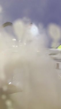 Kanat, özel ekipman ve spreyleme teknisyeniyle gece vakti uçak dezenfekte işleminin yakın çekim sahnesi. Buz, buhar ve dramatik ışıklandırma soğuk hava koşullarında gerekli havaalanı bakımını vurguluyor. Havacılık güvenliği temaları için ideal.