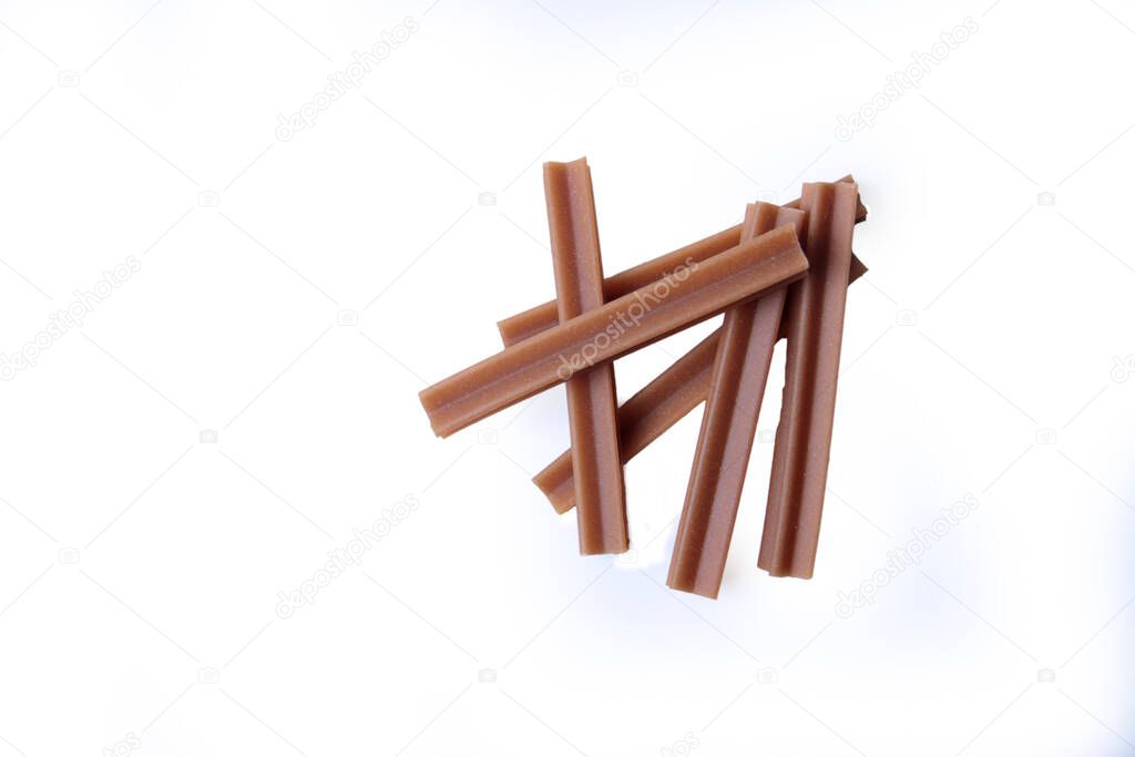 pets food concept - chews - dental sticks for dogs isolated on white background flat lay. Image contains copy space