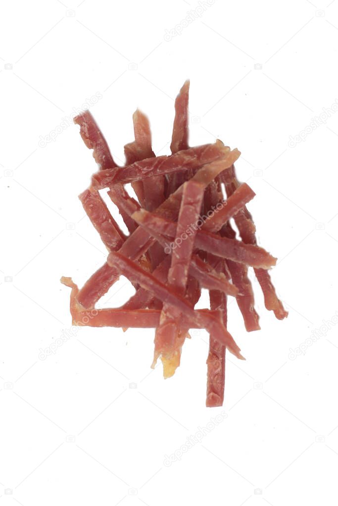 pets food concept - a pile of jerky meat for dogs isolated on white background flat lay. Image contains copy space