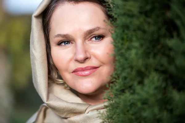 Mujer con pañuelo al lado del árbol —  Fotos de Stock