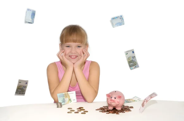 Chica sonriente con dinero volador y alcancía —  Fotos de Stock