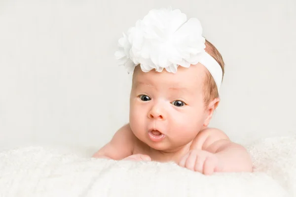 Portrait of newborn baby girl  with white headband — Stock Photo, Image