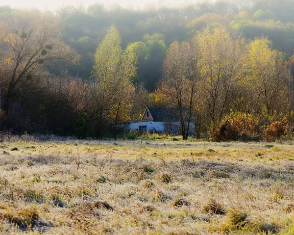 Landscape with an abandoned house in a hilly area, in October. Autumn season in the village. Web banner. Ukraine. Europe.