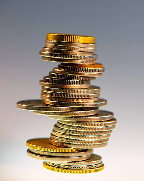 stack of different coins on a light background. Business concept.