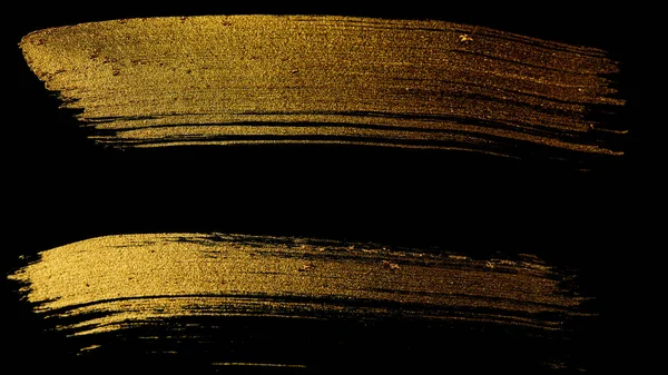 Spuren Von Goldener Farbe Mit Einem Pinsel Auf Schwarzem Hintergrund Stockfoto